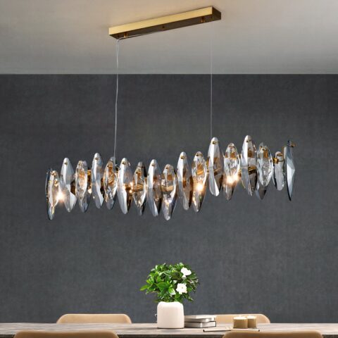 Lampadario salle à manger moderne en cristal et acier inoxydable sur fond gris